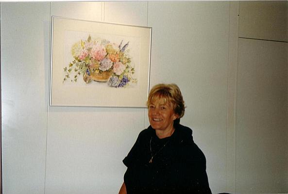 In front of a watercolor